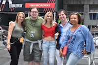 a group of people posing for a photo in front of a building
