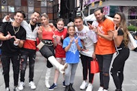 a group of people posing for a picture in front of a building