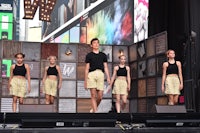 a group of young people standing on a stage