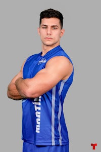 a young man in a blue uniform posing for a photo