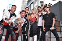 a group of people posing for a picture on a stage