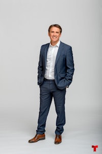 a man in a suit posing for a photo