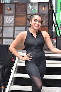 a woman in a black bodysuit posing for a photo